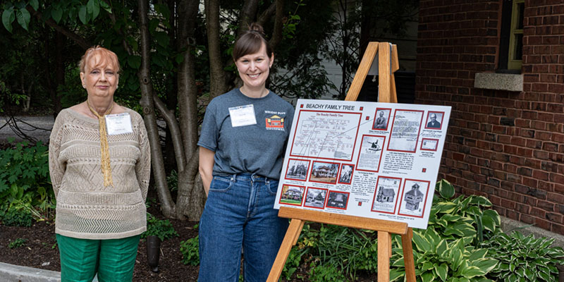 Volunteers present house research boards