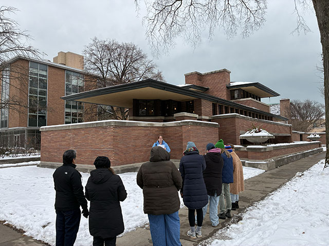 Standing outside of Robie House, educators learn about the history and design of the home.